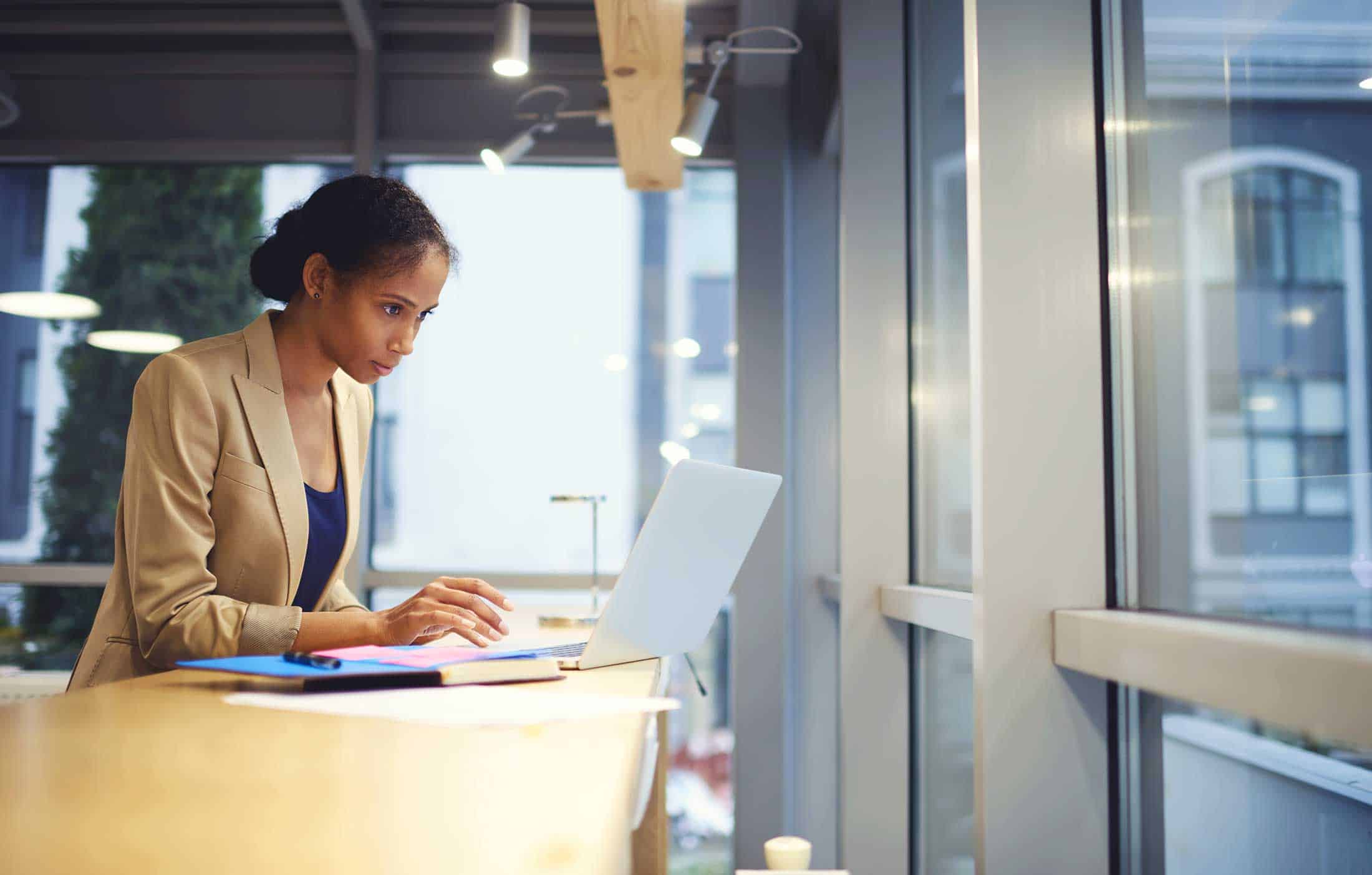 Woman checking events calendar on a laptop